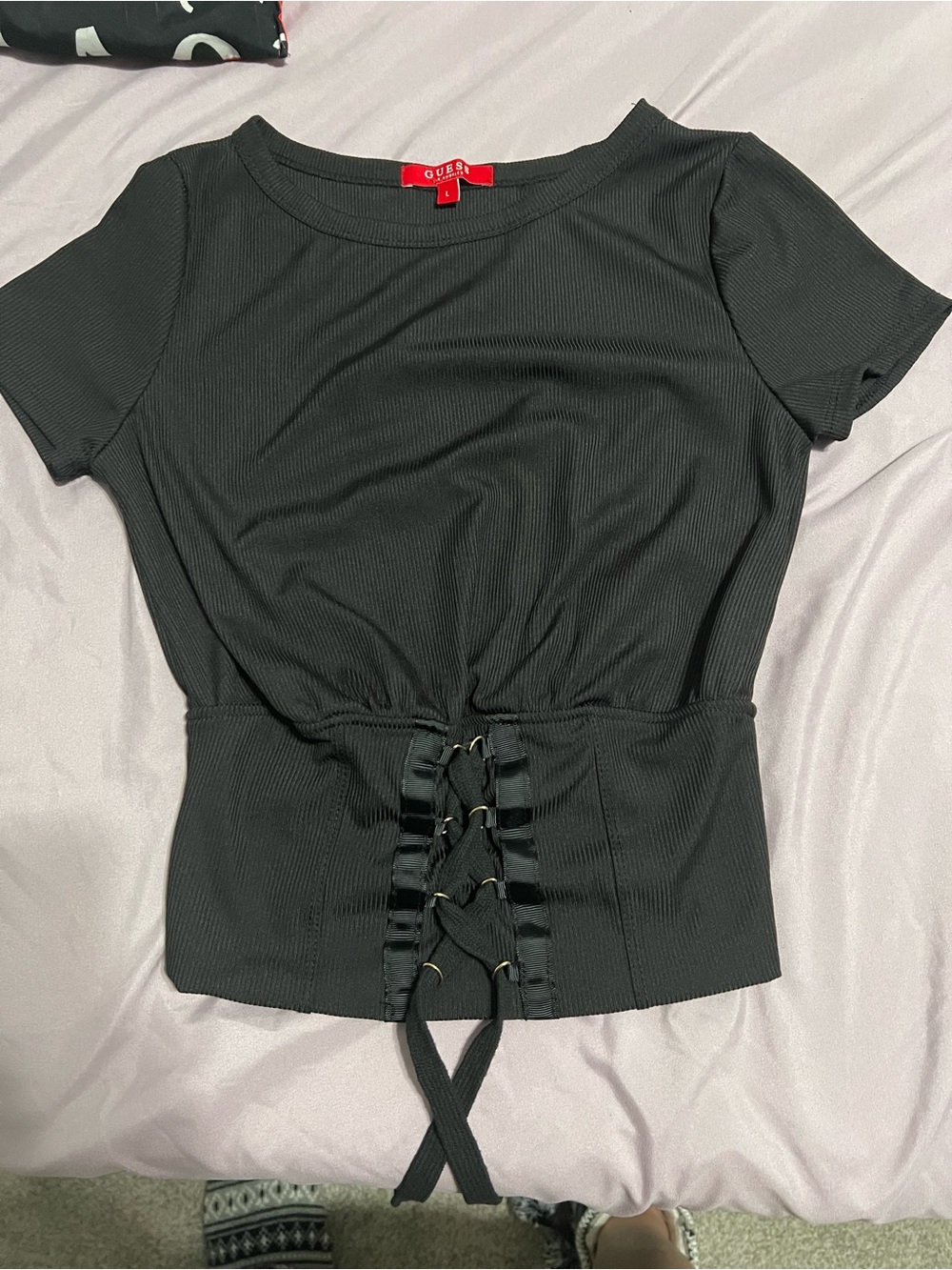 Never worn Guess Black Ribbed Short Sleeve Top with Lace-Up, runs small NOT larg